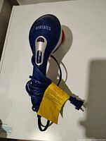 Top view of HoMedics massager showing brand logo, control slider, cord and plug