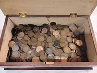 Wooden box filled with numerous large Canadian cents