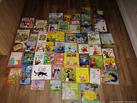 Overview of entire lot laid out on floor showing all books and autograph book
