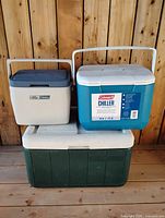 All three Coleman coolers stacked: large green chest, medium teal Chiller, small Lil Oscar