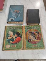 Four books laid out showing covers: blue Fairy Tales, brown Uncle Tom’s Cabin, two Chatterbox 1921 and 1911