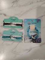 All three packaged bracelets: Fahlo beaded and two Earth & Surf paracord with anchor clasps