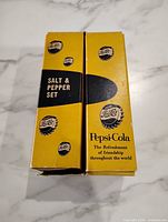 Front of yellow and black Pepsi-Cola Salt & Pepper Set box