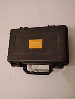Exterior of black TOPTES carrying case showing brand label