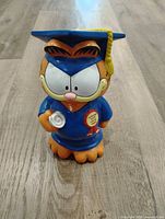 Front view of Garfield graduation coin bank