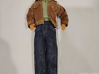 Full view of Ken doll wearing jacket, shirt and jeans