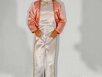 Full front view of Ken doll in peach jacket and white suit