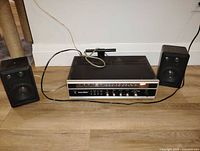 Front view of Solid State TK-75 receiver with paired Insignia speakers