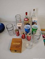 Full lot showing whiskey set box, three Williams Landing mugs, three Coca-Cola mini cans
