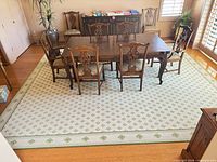 Full view of rug under dining table showing overall pattern and size in room