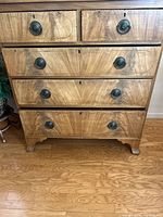 Front view showing five drawers with brass ring pulls