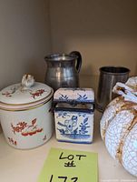 Group shot of porcelain jar, tin, pumpkin, pewter pitcher and tankard