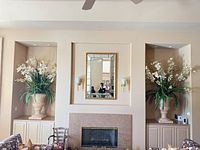 Room view showing both urn planters flanking fireplace