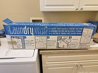 Retail box showing LaundryMate branding and installation illustrations