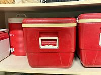 Large cooler and beverage jug on shelf