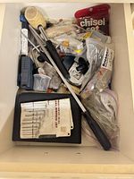 Drawer containing assorted hand tools and hardware