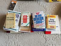 Two stacks of assorted health reference books on carpet