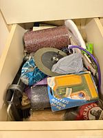 Drawer with sanding belt roll, grinding wheel, packaged scraper, sanding sponge, clamp parts, other accessories