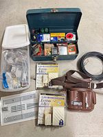 Full lot overview including toolbox, belt, doorbells, wire, hinges, plastic bin