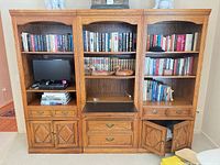 Front view of three-piece unit highlighting central bookcase features