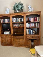 Three-piece wall unit showing center bookcase included in lot