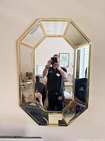 Front view showing full octagonal mirror and brass-tone frame