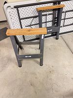 Two foldable steel sawhorses with wood tops, Hirsh logo visible