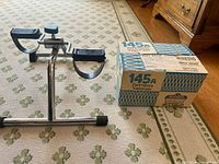 Pedal exerciser beside Devilbiss 145A vaporizer box on carpet