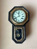 Full view of wall clock showing octagon top and drop bottom case