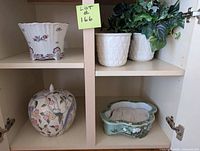 Cabinet view showing all five ceramic pieces in lot