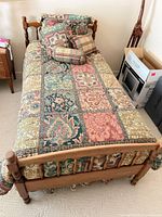 Bed frame with mattress, comforter and pillows in place