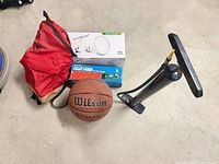 Group shot: basketball, pump, backpack, LED bulb box, foot pump box