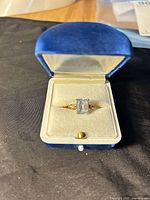 Ring in open blue presentation box, top view