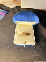 Ring in open case showing ruby and diamonds