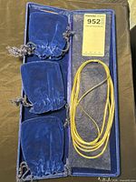 Full view of necklace in case with pouches