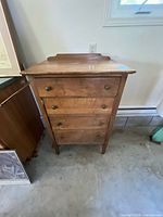 Front view of solid wood dresser with four drawers