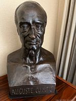 Front view of bronze bust showing inscription AUGUSTE COMTE