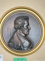 Full view of framed bronze medallion