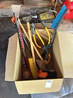 Overall view of box with mixed cleaning tools and hose splitter