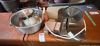 Overall lot showing electric slicer, aluminum pot filled with utensils and pans