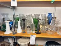 Shelf with majority of vases, candlesticks and glass blocks visible