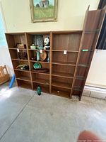 Full front view showing three wide bookcases and one narrow tower assembled side by side