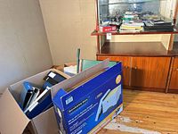 Wide view showing binders inside Bankers Box and stacked office items