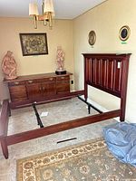 Room view showing complete bed frame assembly with dresser in background (dresser not included)