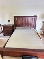 Full view of assembled bed frame with mattress and matching nightstand