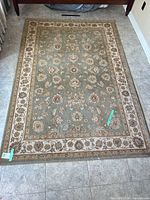 Full view of rectangular sage green oriental rug