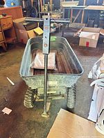 Front view of garden wagon showing tub, handle, tires, and Res-Q-Mate bag inside