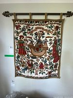 Full view of tapestry on hanging rod showing overall design and colors