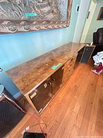 Sideboard top and left side, showing burl veneer and smoked glass door