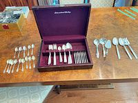 All flatware pieces laid out with case open showing contents